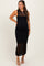woman wearing a black sleeveless maternity dress with crochet details and a visible baby bump