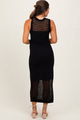 woman wearing a black crochet back maternity dress, showing a fitted silhouette and mid-length style