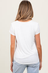 woman wearing a white short sleeve maternity top, viewed from the back, paired with light blue jeans