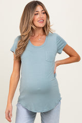 woman wearing a teal maternity t-shirt with a pocket and visible baby bump