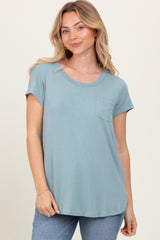woman wearing a light blue short sleeve t-shirt with a front pocket and relaxed fit, paired with jeans