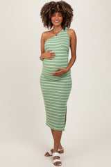 woman wearing a green and white striped one-shoulder maternity dress showcasing her baby bump