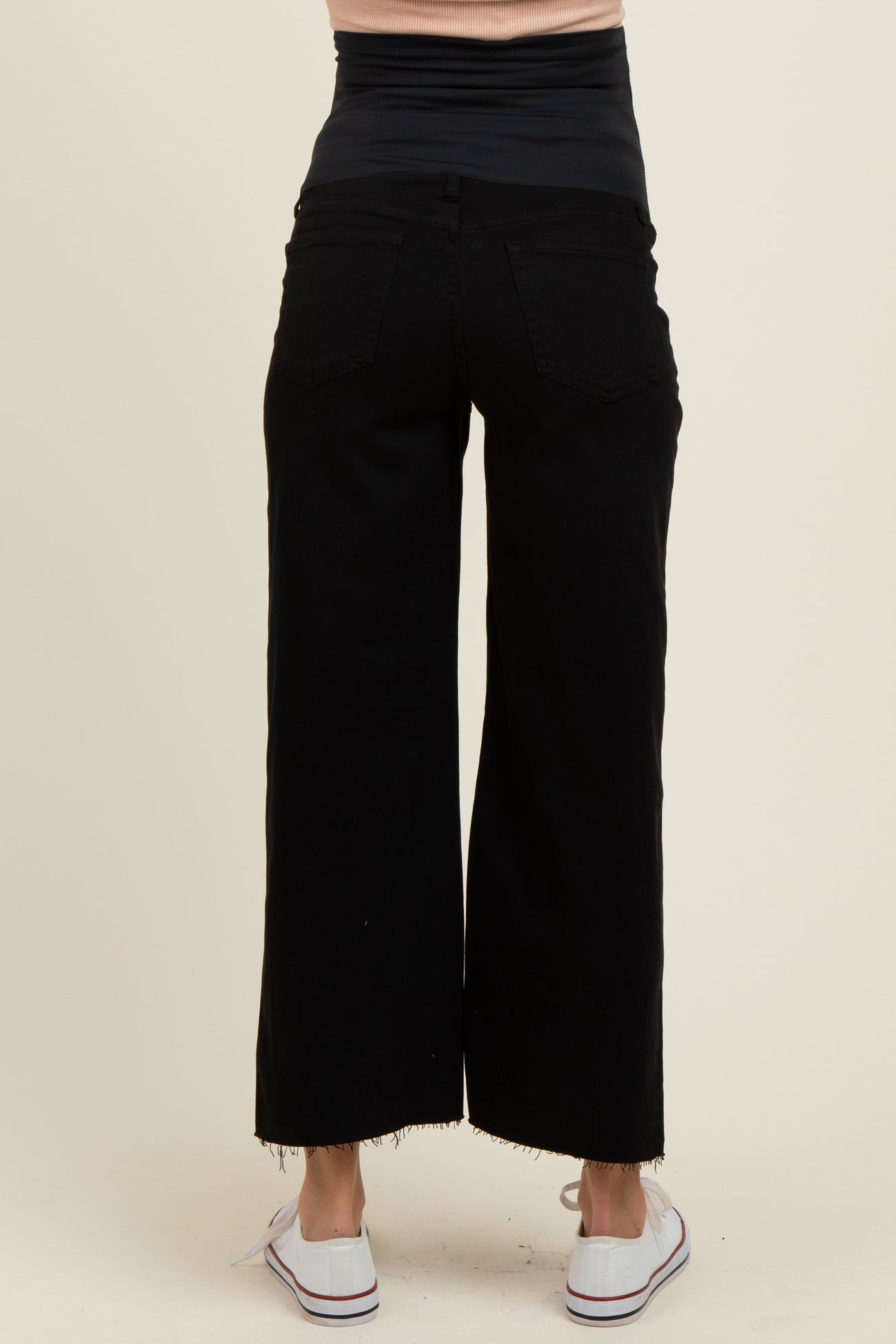 woman wearing black maternity wide-leg jeans with a stretchy waistband, viewed from the back