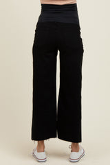 woman wearing black maternity wide-leg jeans with a stretchy waistband, viewed from the back