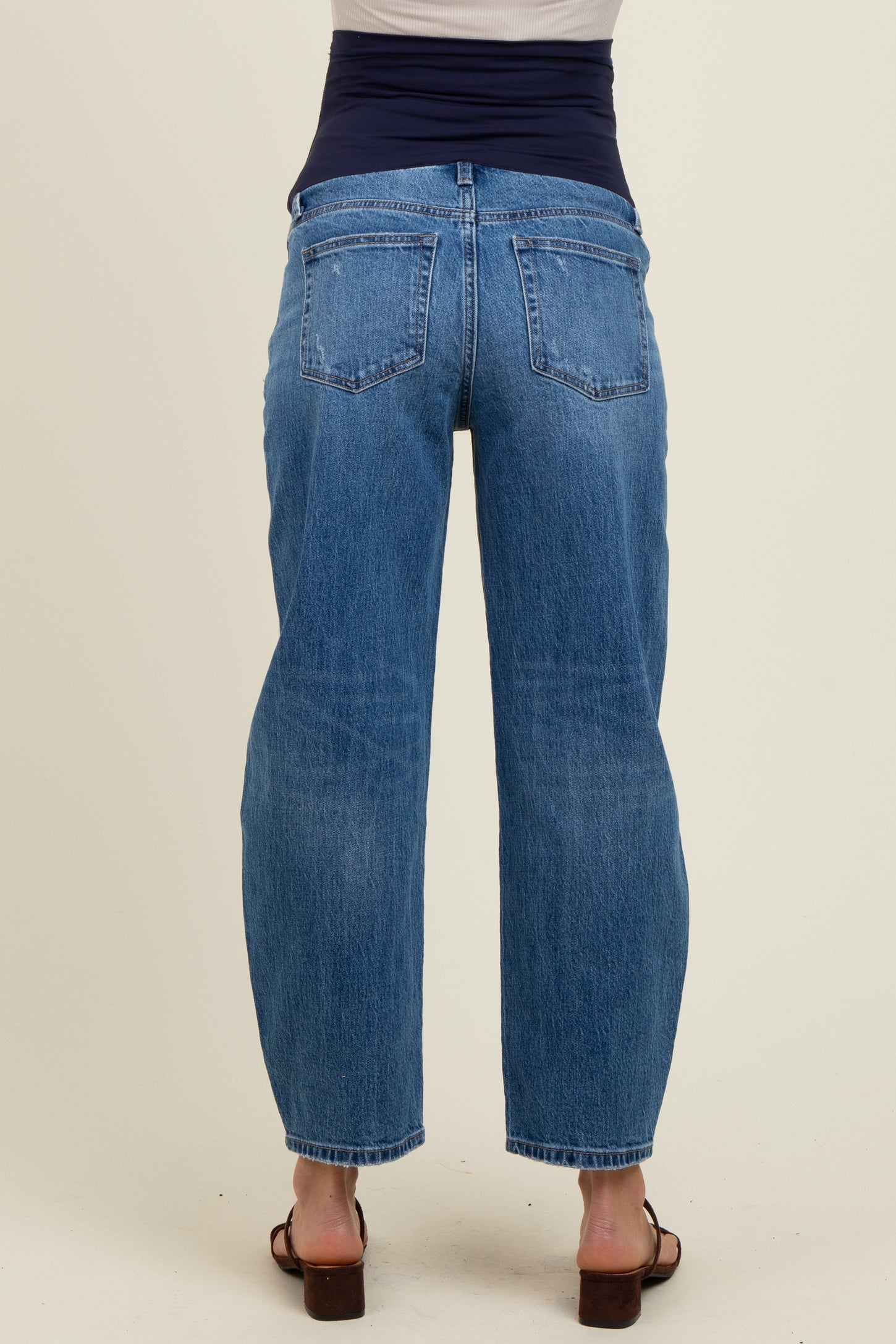 woman wearing light blue maternity jeans with a high waistband, seen from the back