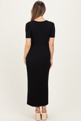 woman wearing a black ribbed maternity maxi dress with short sleeves, showing a fitted silhouette from the back