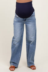 woman wearing light blue maternity wide-leg jeans with a navy waistband and a visible baby bump
