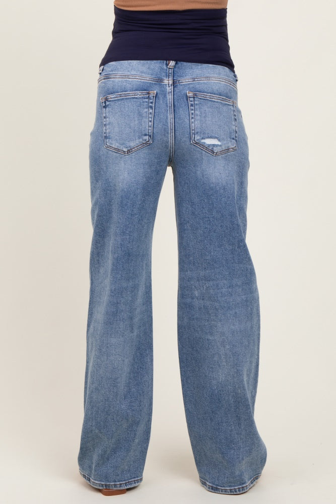 woman wearing light blue maternity jeans with a relaxed fit and wide legs, showing the back view