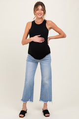 woman wearing a black ribbed maternity tank top and distressed light wash jeans, holding her baby bump
