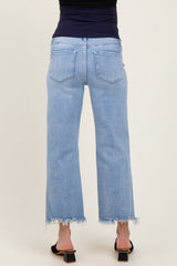 woman wearing light blue maternity wide-leg jeans with a frayed hem, showing her back view.