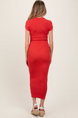 woman wearing a red ribbed maternity dress with short sleeves and a fitted silhouette, viewed from the back