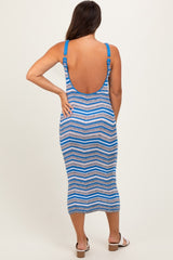 woman wearing a blue and white striped maternity midi dress with a scoop back and adjustable straps