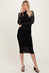woman wearing a black lace long sleeve midi dress with a fitted silhouette and a stylish turtleneck design