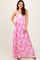 woman wearing a pink floral maxi dress with adjustable straps and a fitted bodice