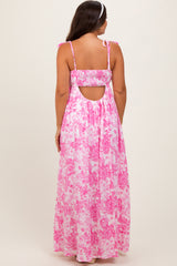 woman wearing a pink floral maternity maxi dress with a smocked back and tie straps