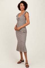 woman wearing a striped midi dress with a flattering ruffle detail and fitted silhouette