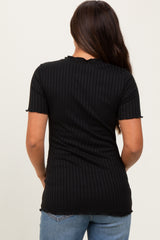 woman wearing a black ribbed short sleeve maternity top, showing the back view, paired with light blue jeans