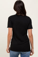 woman wearing a black ribbed t-shirt with short sleeves and a scalloped hem