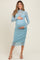 woman wearing a light blue long sleeve maternity dress with ruching, showcasing her baby bump