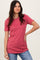 woman wearing a raspberry pink ribbed top with scalloped edges and short sleeves paired with light blue jeans