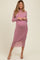 woman wearing a light pink long sleeve maternity dress with side ruching and a visible baby bump