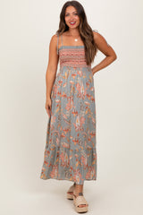 woman wearing a gray floral maternity maxi dress with smocked bodice and spaghetti straps