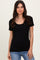woman wearing a black short sleeve scoop neck top with a fitted silhouette and paired with light blue jeans