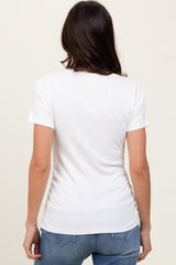 woman wearing a fitted white short sleeve top from the back with a slight gathering detail at the sides
