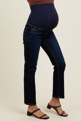 woman wearing dark blue maternity jeans with a stretchy waistband, showcasing her baby bump.