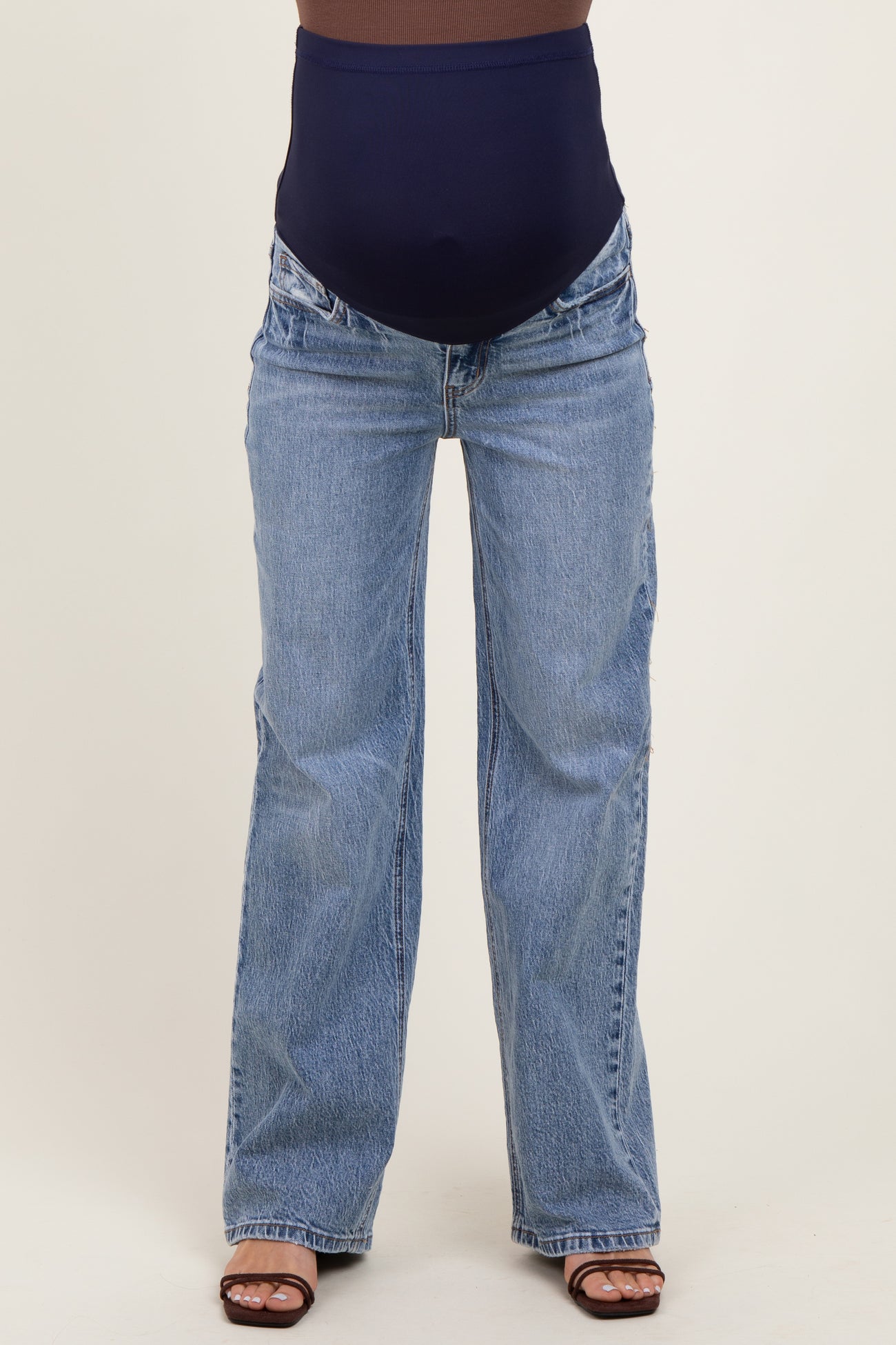 maternity wear featuring a pair of flared blue jeans with a navy supportive belly band