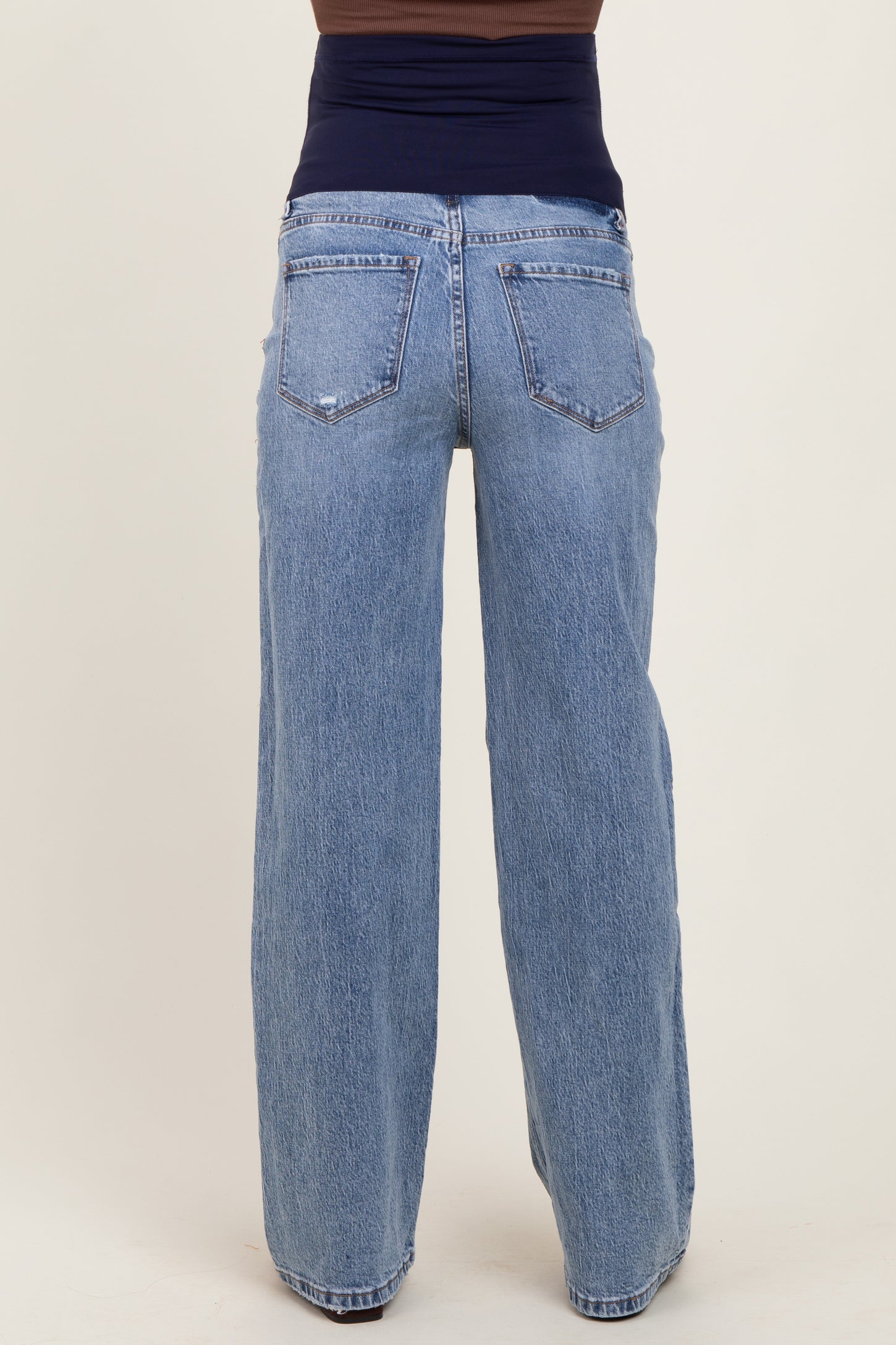 maternity wear wide leg light blue jeans with a mid-rise waistband, shown from the back