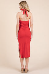 woman wearing a red strapless midi dress with ruching and a back tie detail, viewed from the back