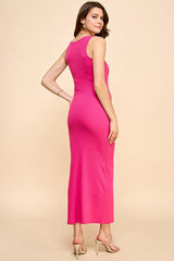 woman wearing a fitted pink maxi dress, side view, with a scoop neckline and back detailing, paired with high-heeled sandals