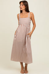woman wearing a brown and white striped maxi dress with pockets and wide straps