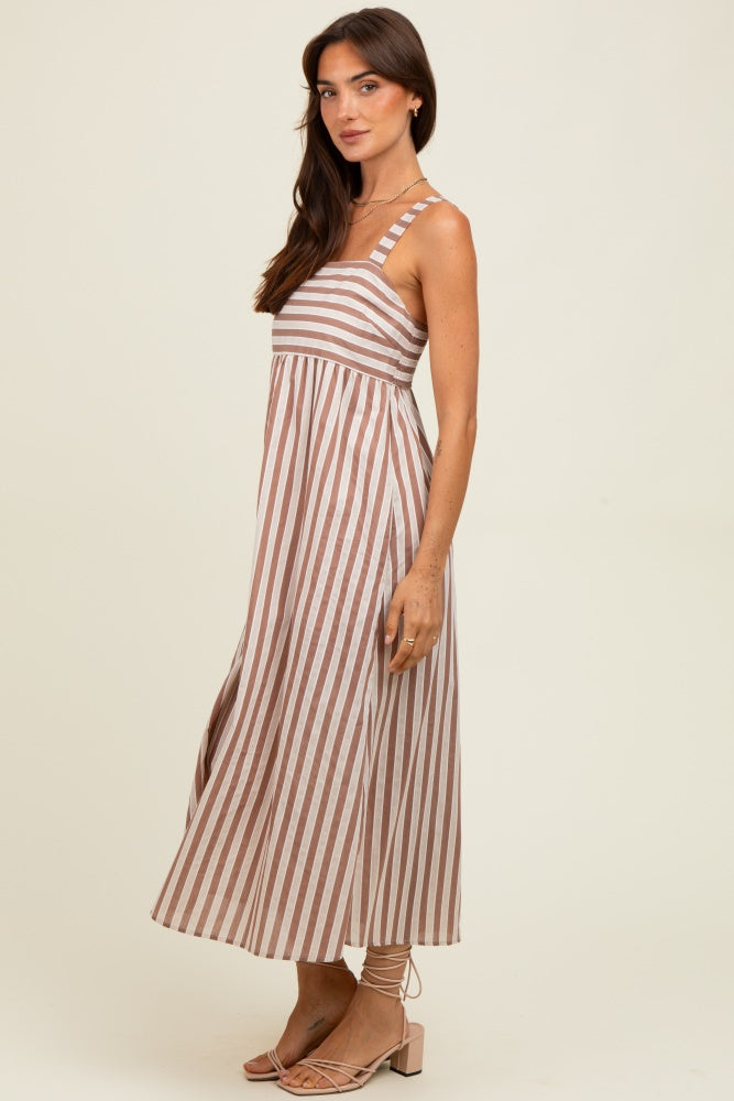 woman wearing a light brown and white striped maxi dress with wide straps and a flared skirt