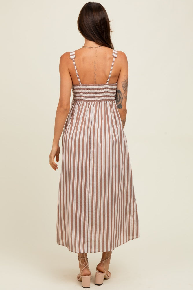 woman wearing a brown and white striped maxi dress with smocked back detail and spaghetti straps
