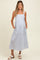 woman wearing a blue and white striped maternity dress with pockets and a baby bump visible