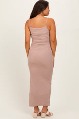 woman wearing a striped maternity maxi dress with spaghetti straps, showing a fitted silhouette from the back