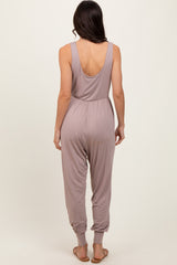 woman wearing a light mauve sleeveless jumpsuit with a low back and tapered legs