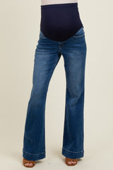 woman wearing dark blue maternity flared jeans with a supportive over-the-bump waistband