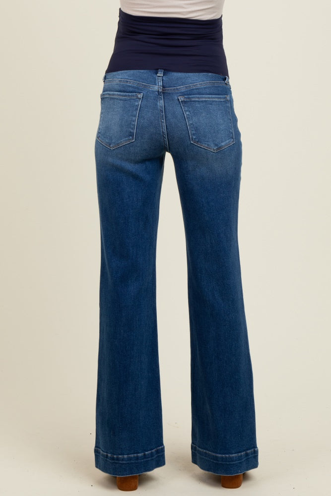 woman wearing dark blue maternity jeans with a flared leg, seen from the back