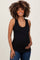 woman wearing a black ribbed maternity tank top and gently holding her baby bump