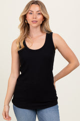 woman wearing a black ribbed tank top paired with light blue jeans