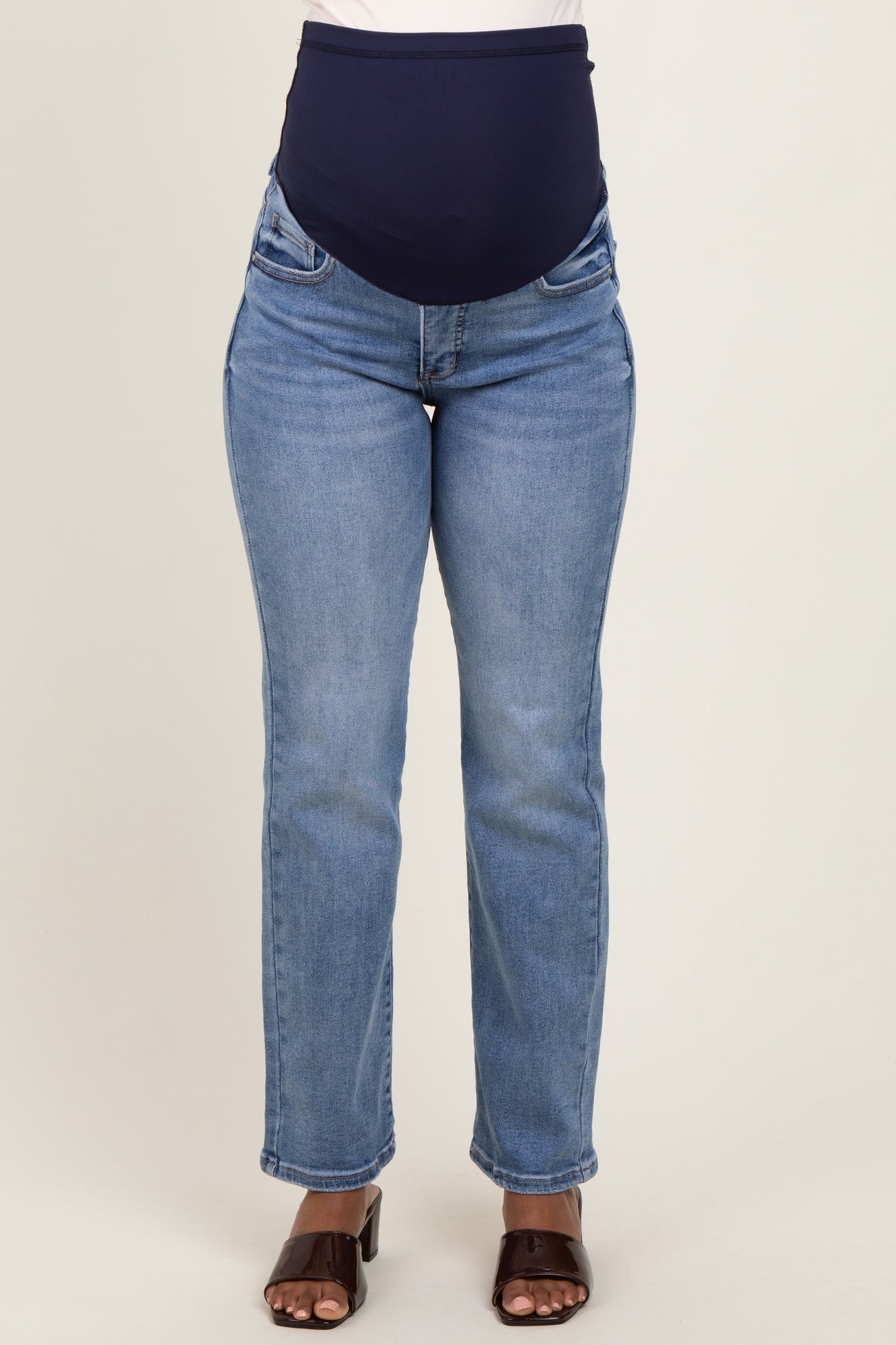 woman wearing light blue maternity jeans with a dark blue over-the-bump waistband