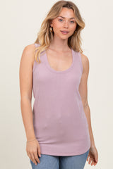 woman wearing a light purple ribbed sleeveless top with a scoop neckline and slim fit, paired with blue jeans