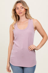 woman wearing a light purple ribbed tank top with a scoop neckline and styled with blue jeans