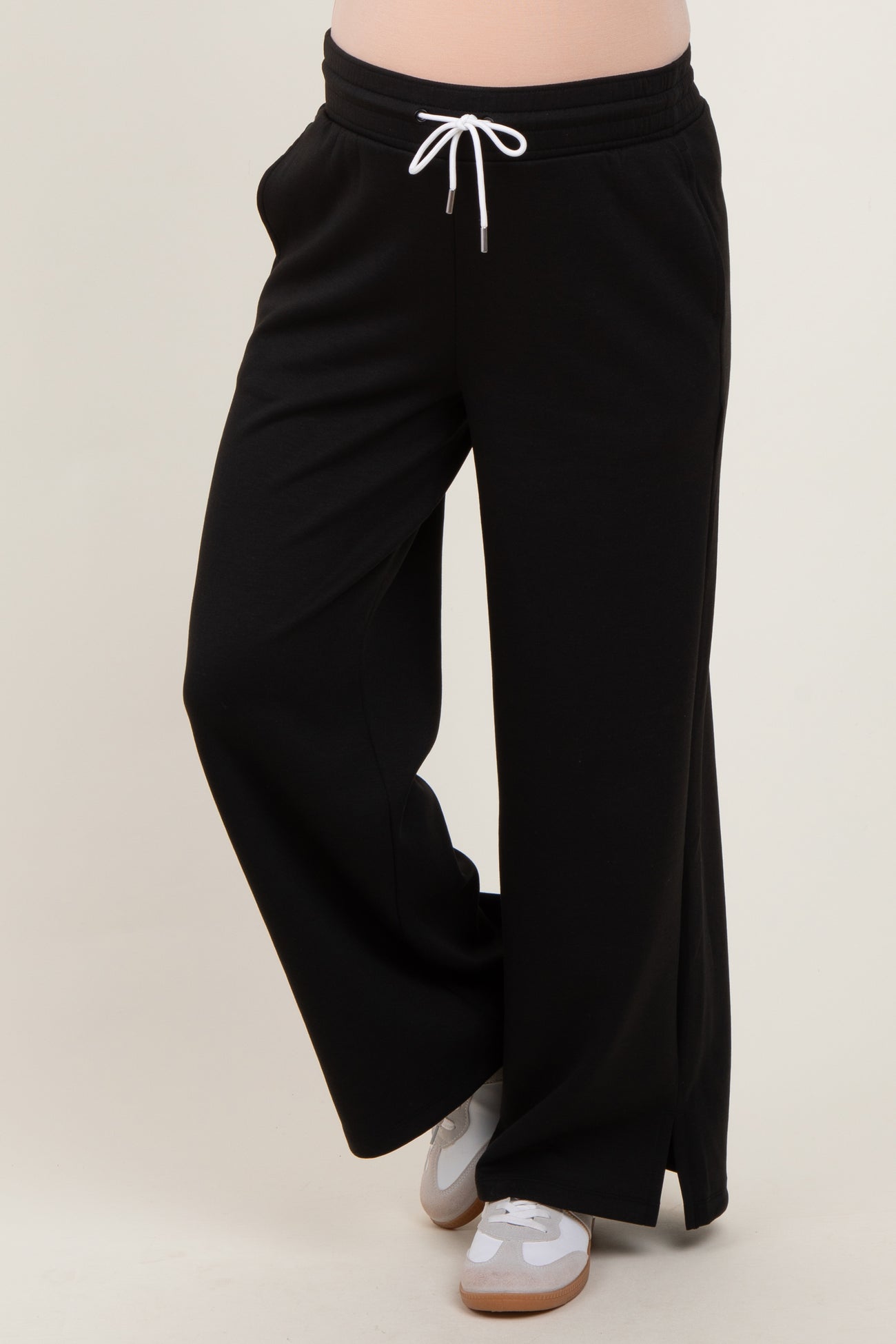 woman wearing black maternity lounge pants with white drawstring and side slits
