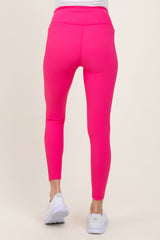 woman wearing bright pink maternity leggings, view from the back