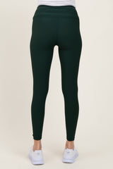 woman wearing green maternity leggings, viewed from the back