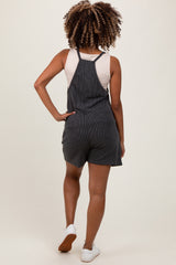 woman wearing a striped maternity romper with a fitted bodice and loose shorts, shown from the back